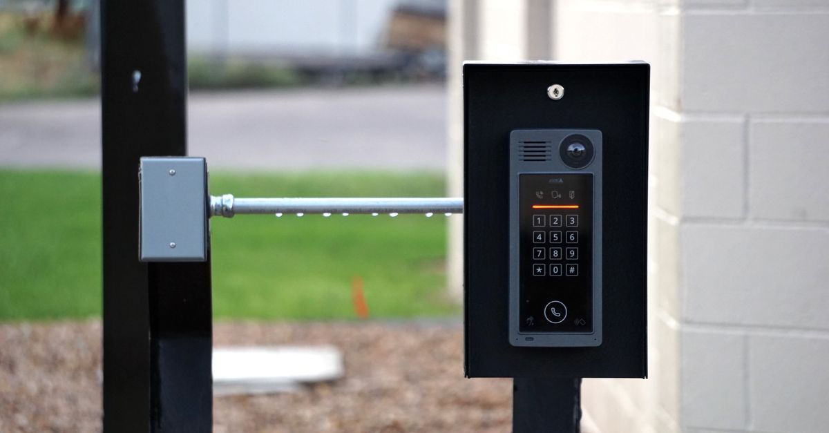 Outdoor intercom mounted at a residential building entrance, ensuring security and communication.