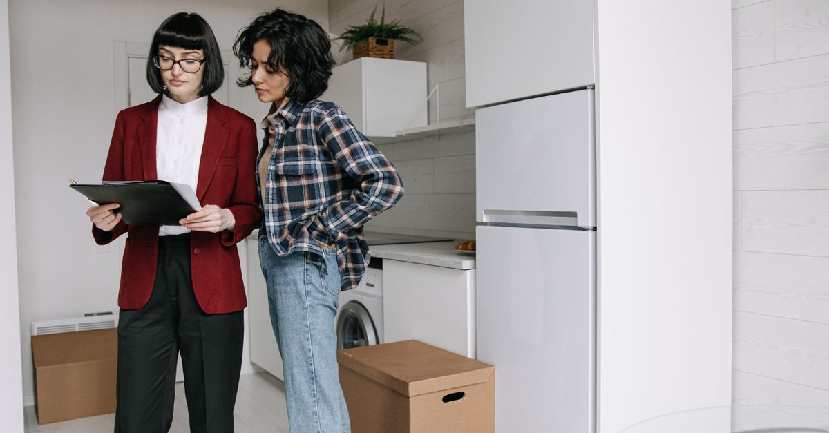 Person reviewing property-related information on a clipboard.