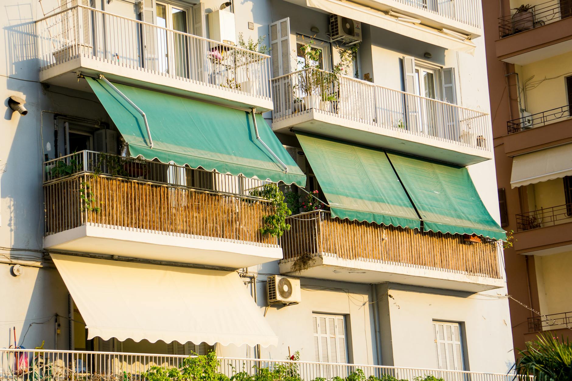 Close-up view of balconies with green awnings in Thessaloniki, Greece.